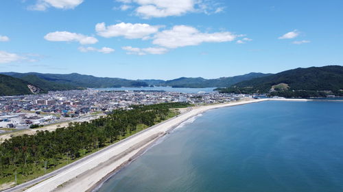 Panoramic view of sea and city against sky