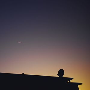 Low angle view of silhouette bird flying against sky