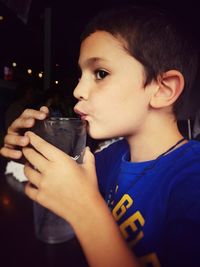 Portrait of boy drinking water from glass