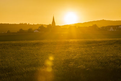 Scenic view of field against sky during sunset