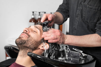 Cropped image of man repairing water