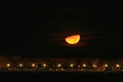 Illuminated lights against sky at night