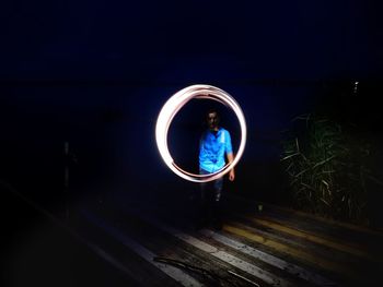 Blurred motion of man standing at night