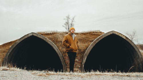 Man standing on field against sky