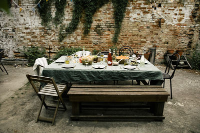 Empty back yard with food and drink set up on dining table
