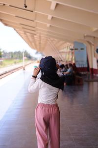 Rear view of woman standing in gym