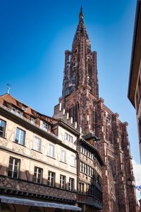 Low angle view of buildings against blue sky