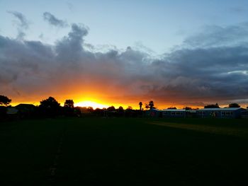 View of golf course against sky during sunset