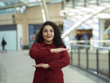 Portrait of woman gesturing while standing indoor