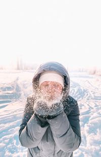 Portrait of woman holding snow