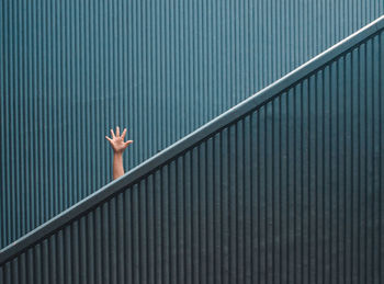 Hand sign on minimal staircase