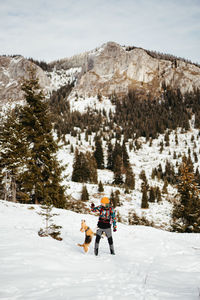People skiing on snow covered landscape