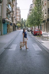 Woman crossing street in city