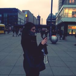 Woman standing on city street