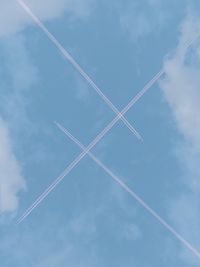 Low angle view of vapor trails in sky