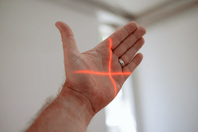 Close-up of man hand against wall