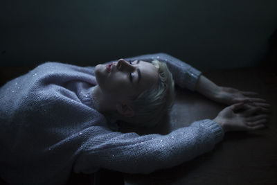 High angle view of woman sleeping on floor at home