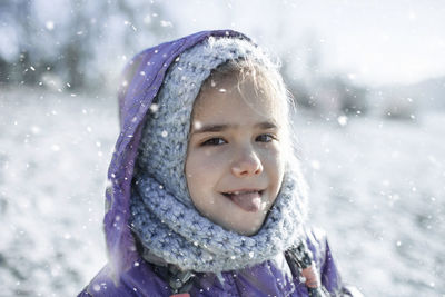 Portrait of smiling girl in snow during winter