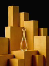 Close-up of boxes with perfume bottle against black background