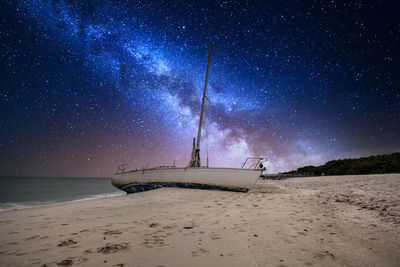 Scenic view of beach against sky at night