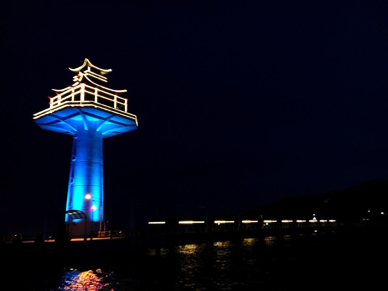 VIEW OF ILLUMINATED TOWER AT NIGHT