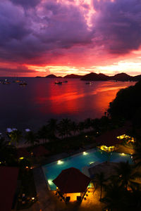 High angle view of illuminated sea against romantic sky