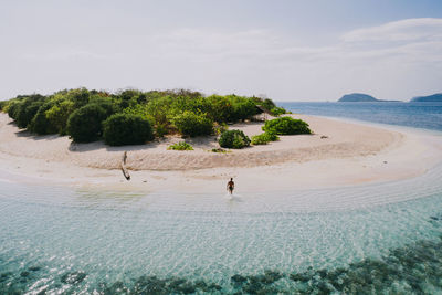 Drone view of man at beach on sunny day