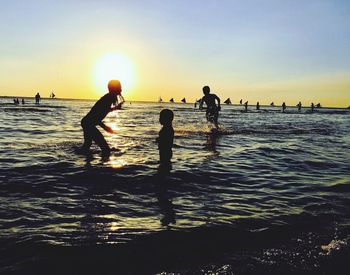 People on beach at sunset