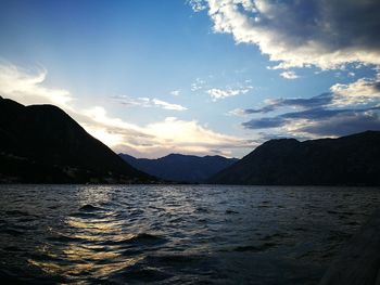 Scenic view of sea and mountains at sunset