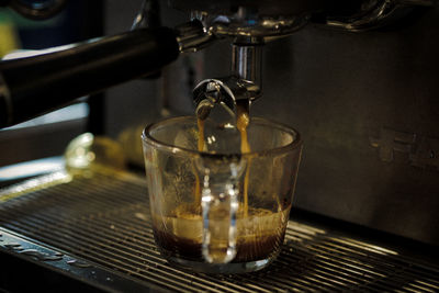 Close-up of glass pouring tea