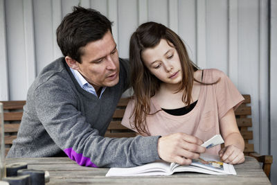 Father and daughter reading a book together