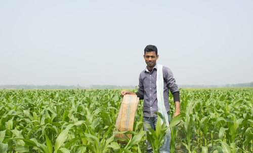 Portrait of young man standing in field