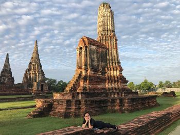 People at temple against sky