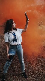 Full length of woman standing against the wall