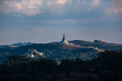 Panoramic view of temple and buildings against sky