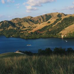 Scenic view of lake and mountains against sky