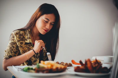 Young woman holding food in plate