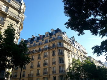 Low angle view of buildings against blue sky