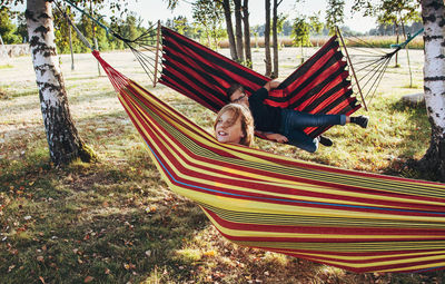 Rear view of boy relaxing on hammock