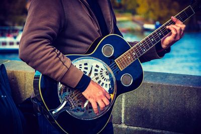 Man playing guitar on street