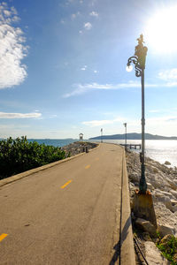 Street by sea against sky