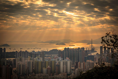 Modern buildings against sky during sunset