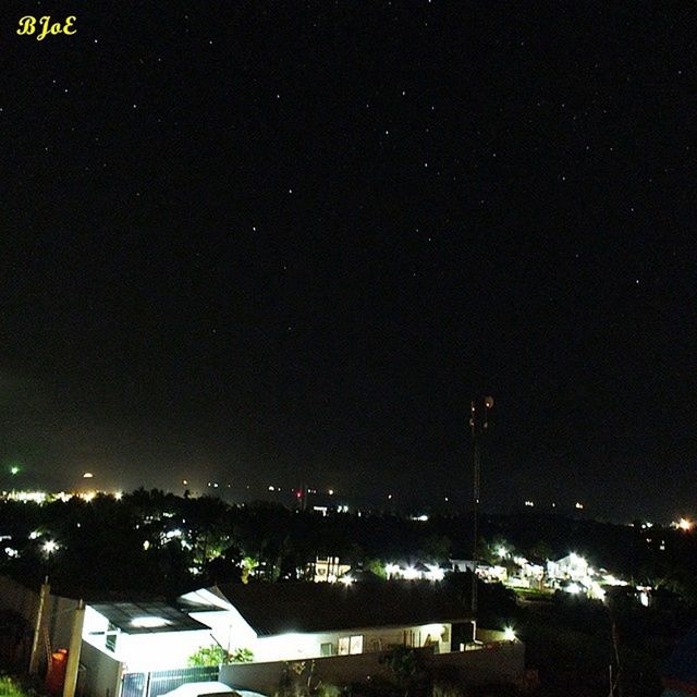 night, illuminated, building exterior, city, built structure, architecture, cityscape, high angle view, sky, dark, residential district, crowded, residential structure, residential building, copy space, outdoors, house, tree, no people, clear sky