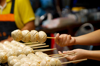 Cropped hand of man preparing food