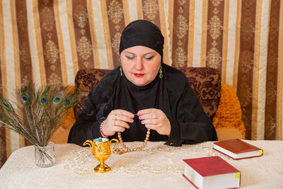 Portrait of woman sitting on table