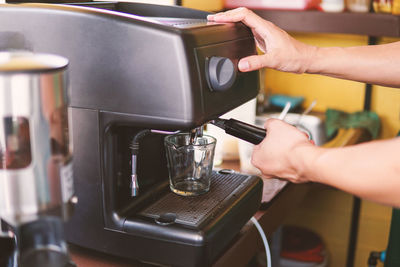 Midsection of person having coffee