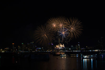Firework display over city at night