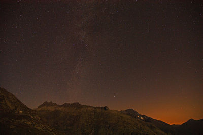 Low angle view of mountain against sky at night