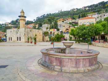 View of fountain in city against sky