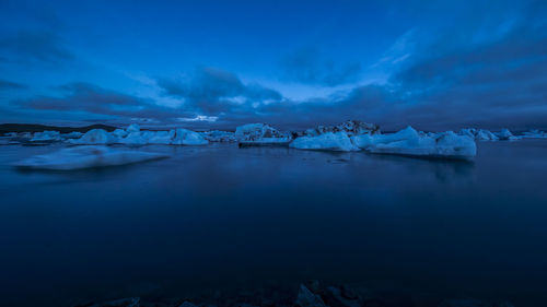 Scenic view of lake against sky during winter